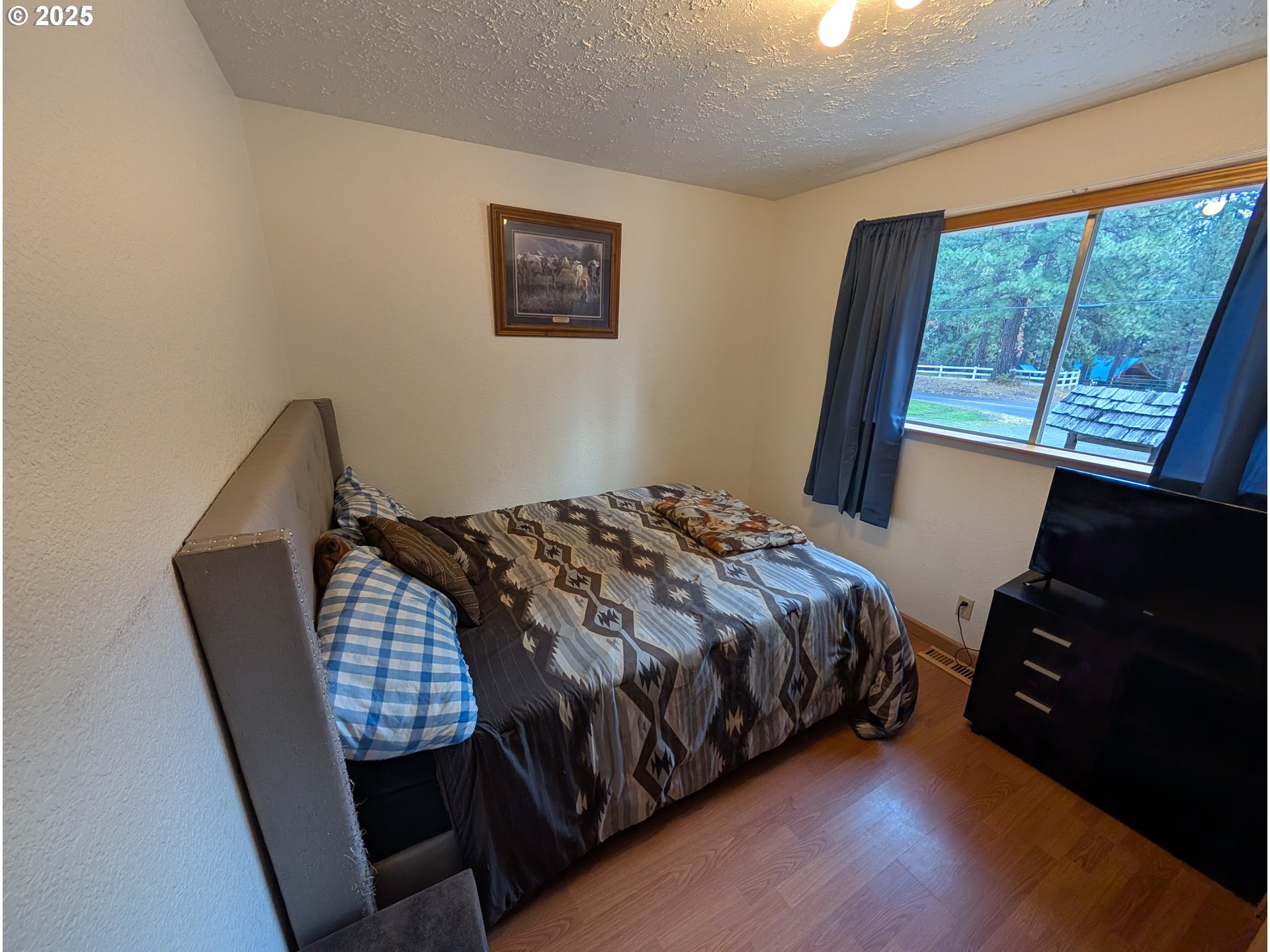 71168 Valley View Road Elgin, OR 97827 - Photo 14 of 32 a bedroom with a bed and wooden floor