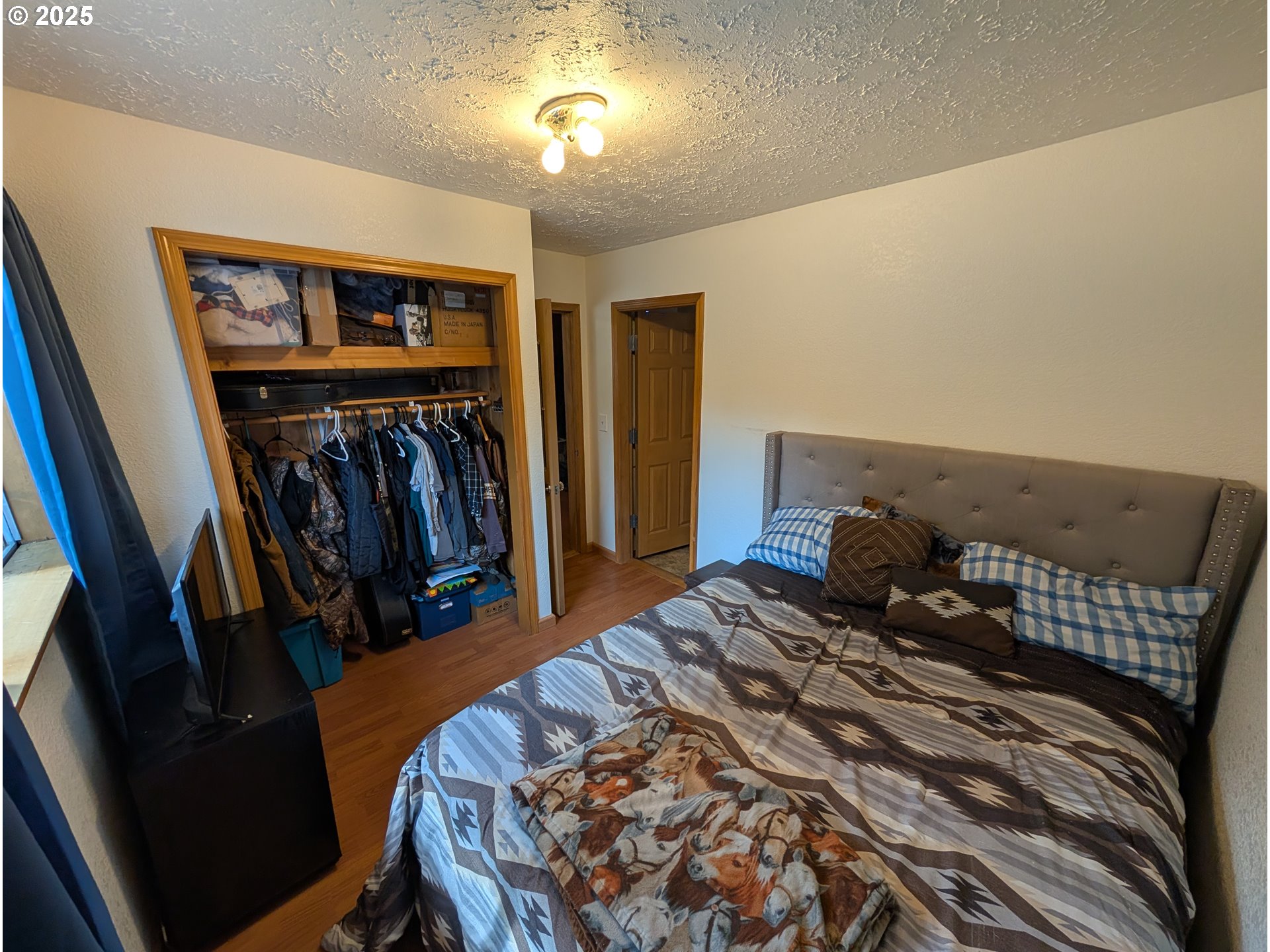 71168 Valley View Road Elgin, OR 97827 - Photo 15 of 32 a bed room with a bed and a walk in closet