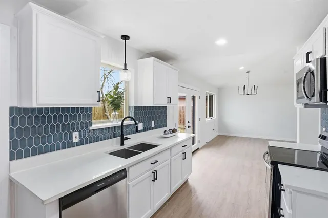a kitchen with a sink and a refrigerator