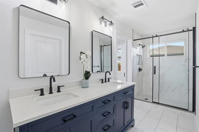 a bathroom with a double vanity sink mirror and double
