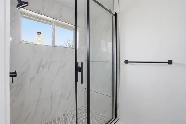 a bathroom with a glass shower door