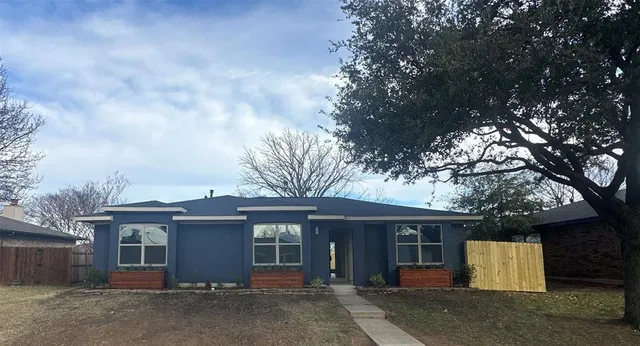 a view of a house with a tree and center