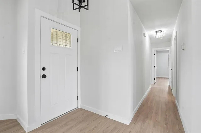 a view of a hallway with wooden floor