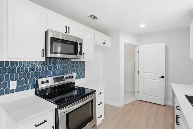 a kitchen with a stove and a microwave