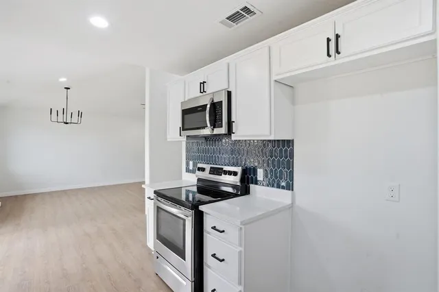 a kitchen with a stove and a microwave