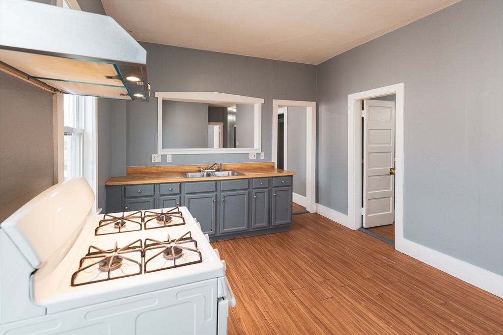 a kitchen that has a sink and a stove in it