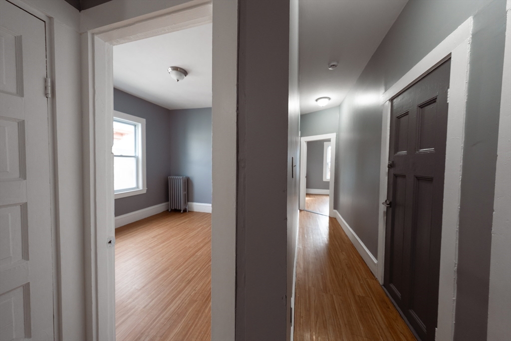 130 Shurtleff Street, Unit 3 Chelsea, MA 02150 - Photo 12 of 17 a view of a hallway with wooden floor and a bathroom