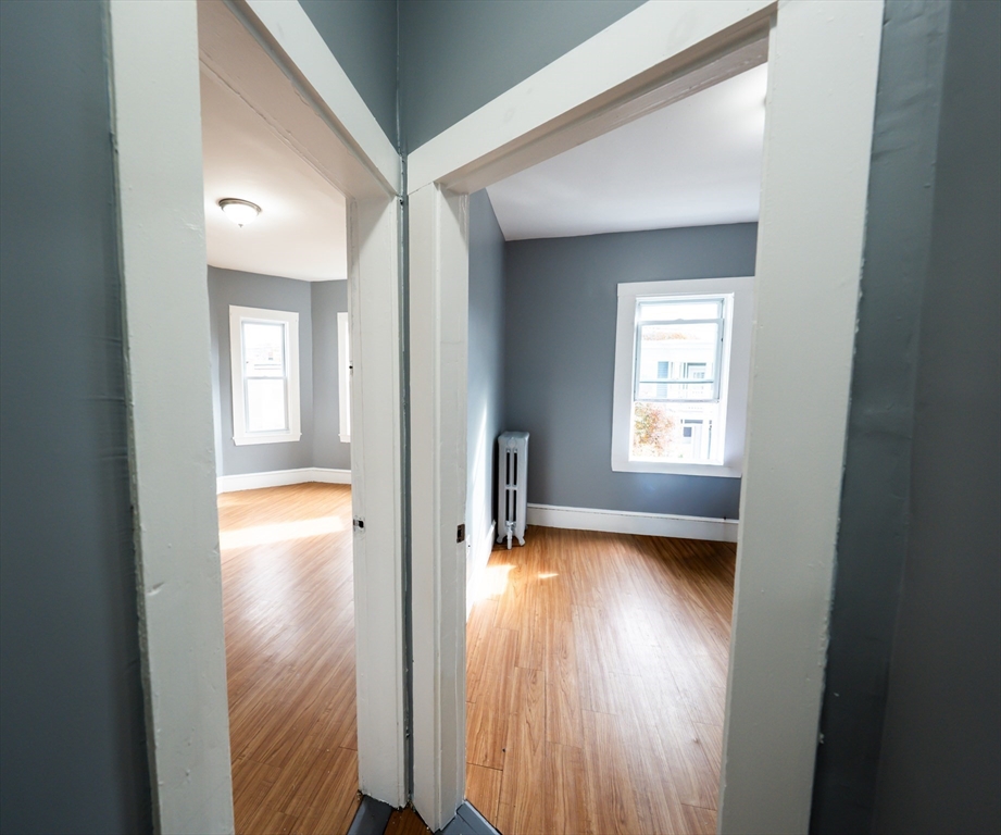 130 Shurtleff Street, Unit 3 Chelsea, MA 02150 - Photo 14 of 17 a view of a hallway with wooden floor and a living room
