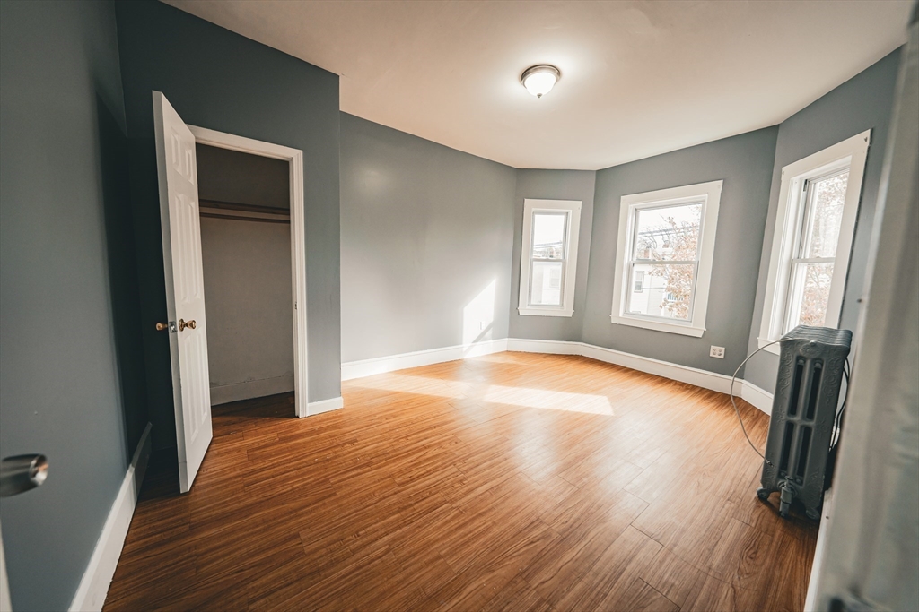 130 Shurtleff Street, Unit 3 Chelsea, MA 02150 - Photo 15 of 17 an empty room with wooden floor and windows