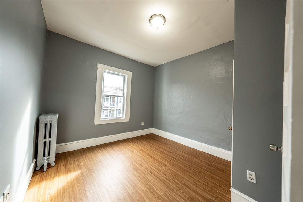 130 Shurtleff Street, Unit 3 Chelsea, MA 02150 - Photo 16 of 17 an empty room with wooden floor and a window