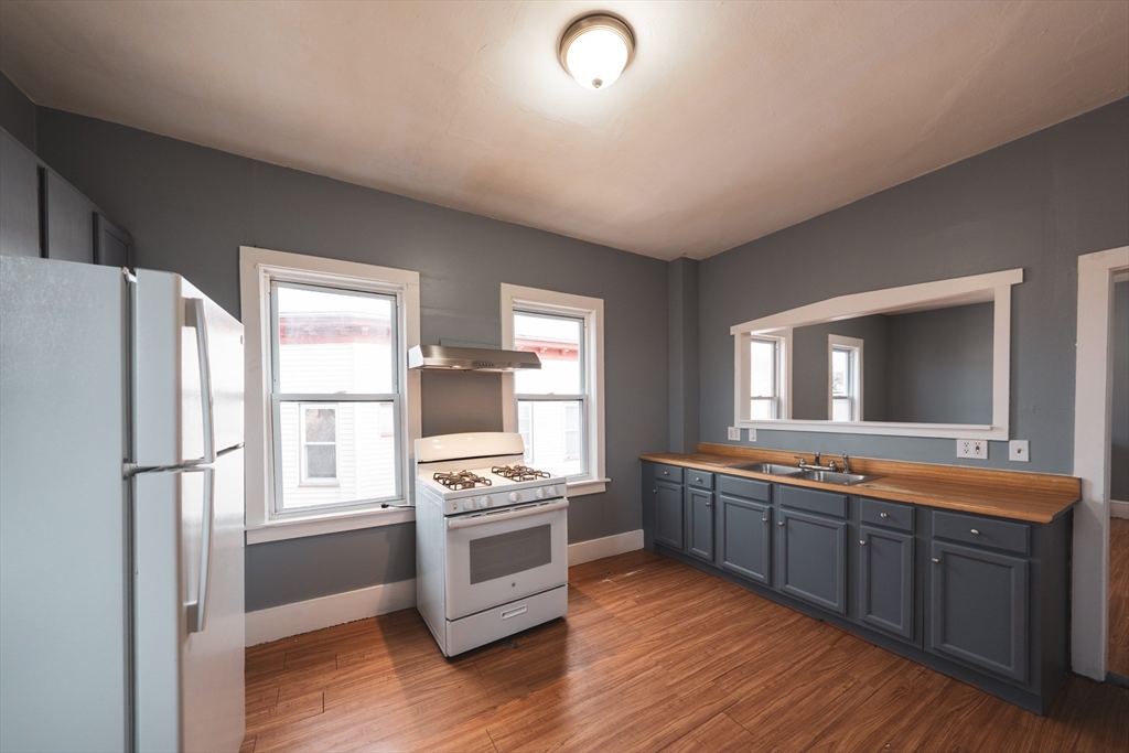 130 Shurtleff Street, Unit 3 Chelsea, MA 02150 - Photo 2 of 17 a large kitchen with stainless steel appliances granite countertop a stove and a refrigerator