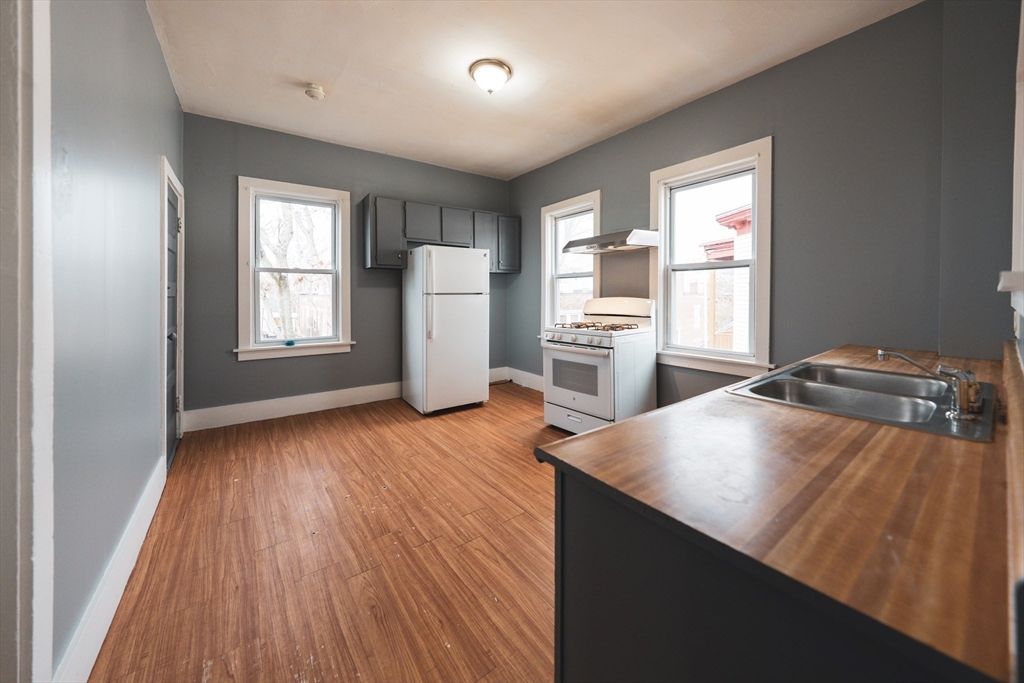 130 Shurtleff Street, Unit 3 Chelsea, MA 02150 - Photo 3 of 17 a view of a kitchen with wooden floor and a window