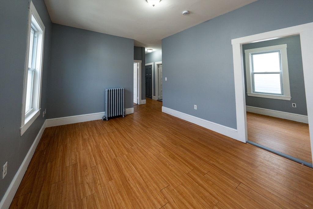 130 Shurtleff Street, Unit 3 Chelsea, MA 02150 - Photo 7 of 17 a view of an empty room with wooden floor and a window