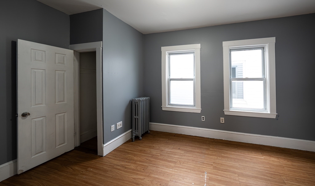 130 Shurtleff Street, Unit 3 Chelsea, MA 02150 - Photo 8 of 17 an empty room with wooden floor and windows