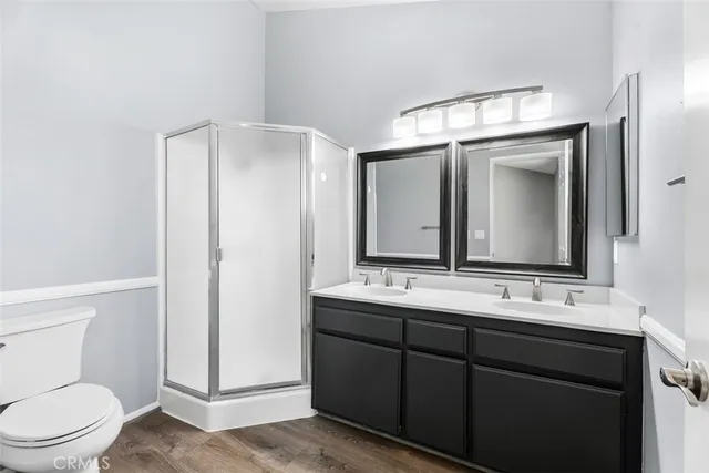 a bathroom with a toilet a sink a mirror and vanity