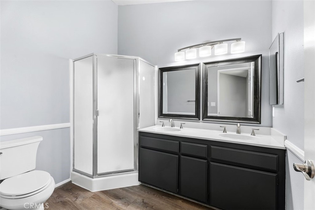 428 West First Street Tustin, CA 92780 - Photo 18 of 35 a bathroom with a toilet a sink a mirror and vanity