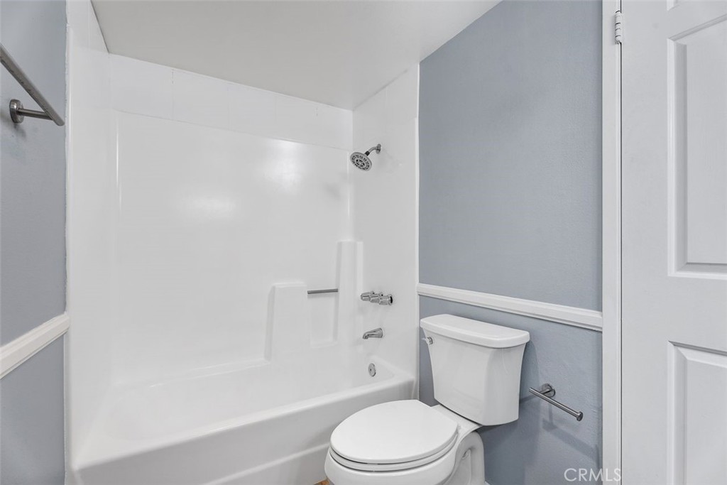 428 West First Street Tustin, CA 92780 - Photo 25 of 35 a white toilet and tub next to a white cabinet