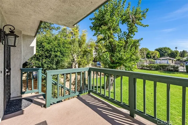 a view of a balcony with wooden floor