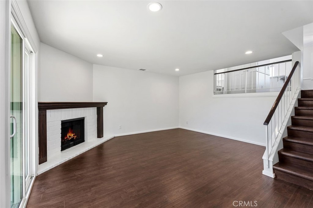 428 West First Street Tustin, CA 92780 - Photo 5 of 35 a view of an empty room with wooden floor fireplace and a window