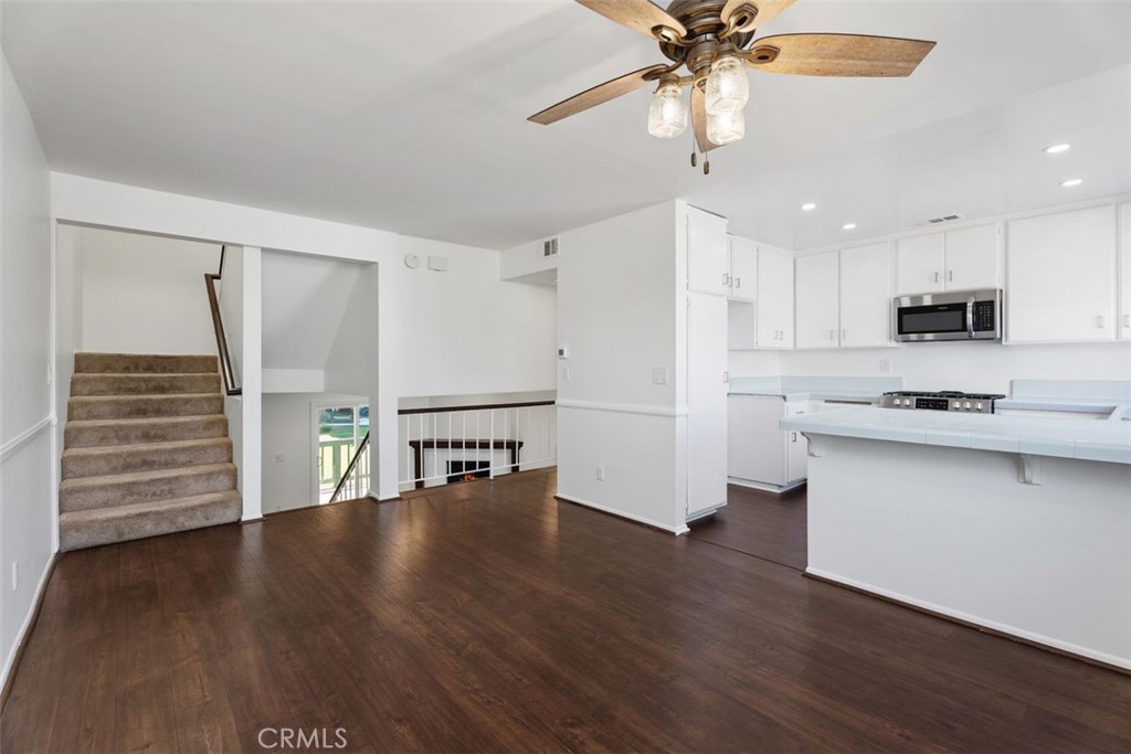 428 West First Street Tustin, CA 92780 - Photo 8 of 35 a kitchen with stainless steel appliances a refrigerator a stove top oven and a ceiling fan