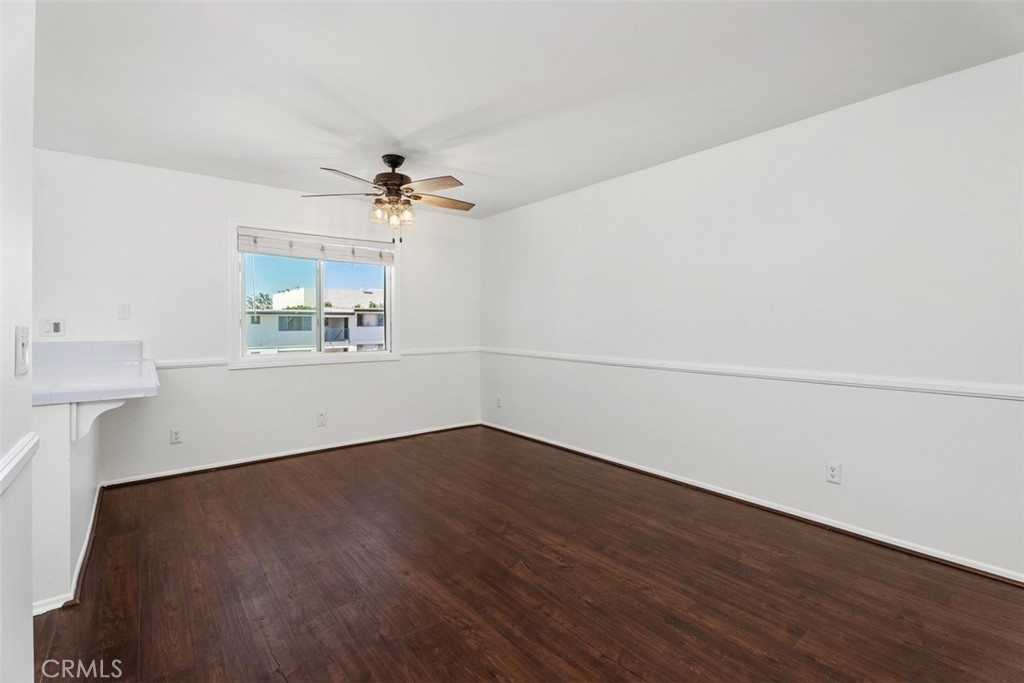 428 West First Street Tustin, CA 92780 - Photo 10 of 35 an empty room with wooden floor and chandelier fan