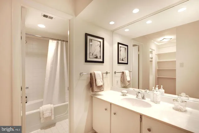 a bathroom with a double vanity sink mirror and