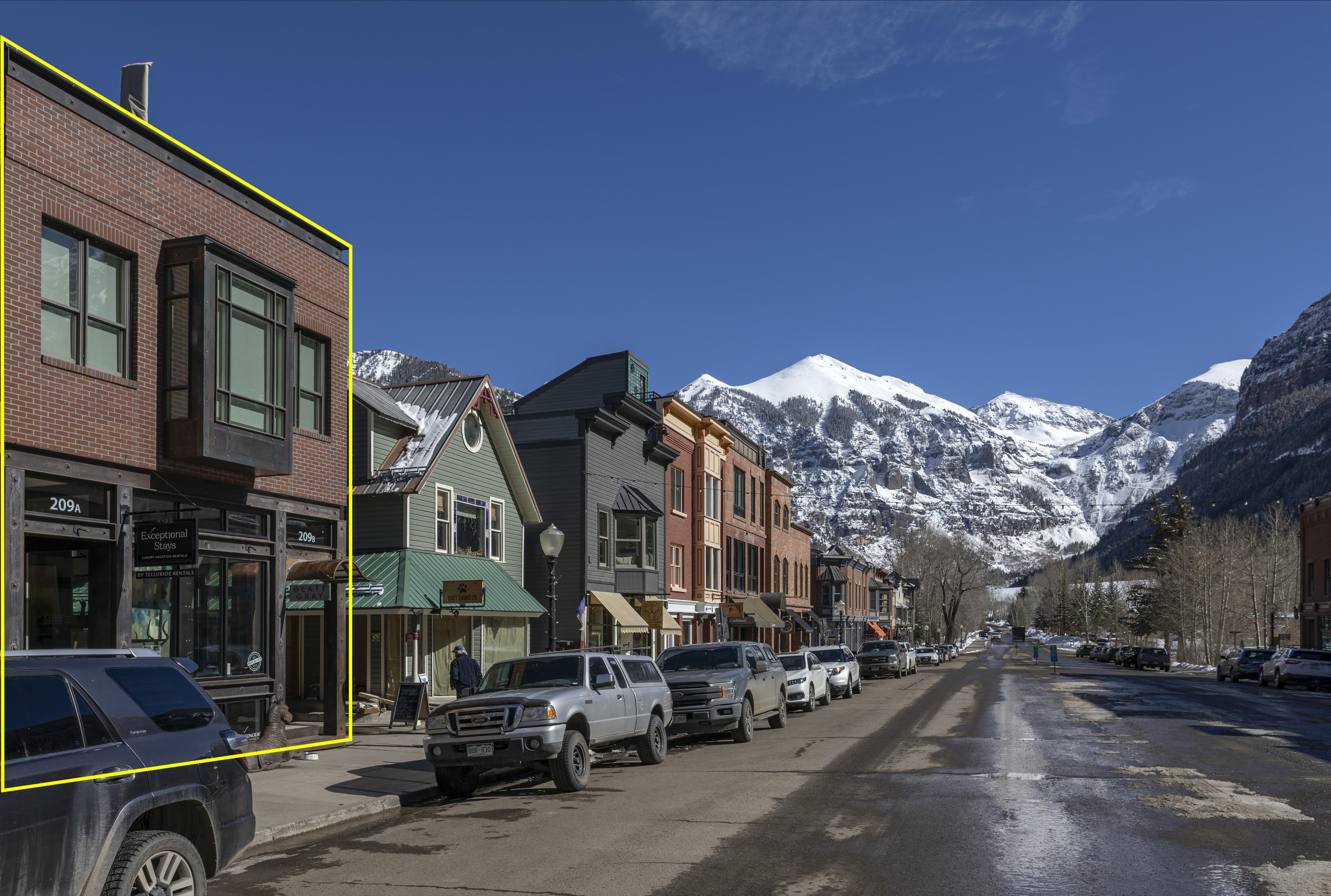209 East Colorado Avenue, Unit R1 EH1 C1 C2 Telluride, CO 81435 - Photo 2 of 14 a city street lined with buildings and cars parked in front of it