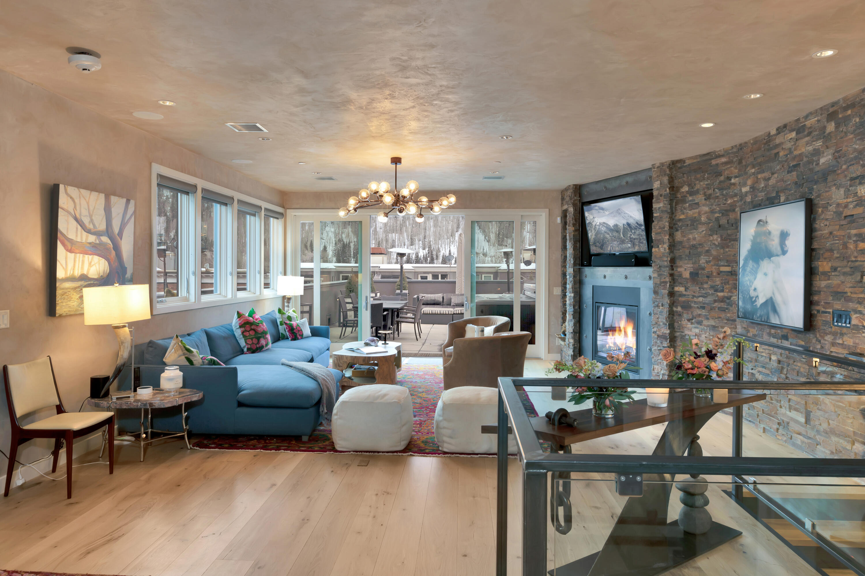 209 East Colorado Avenue, Unit R1 EH1 C1 C2 Telluride, CO 81435 - Photo 8 of 14 a living room with fireplace furniture and a chandelier