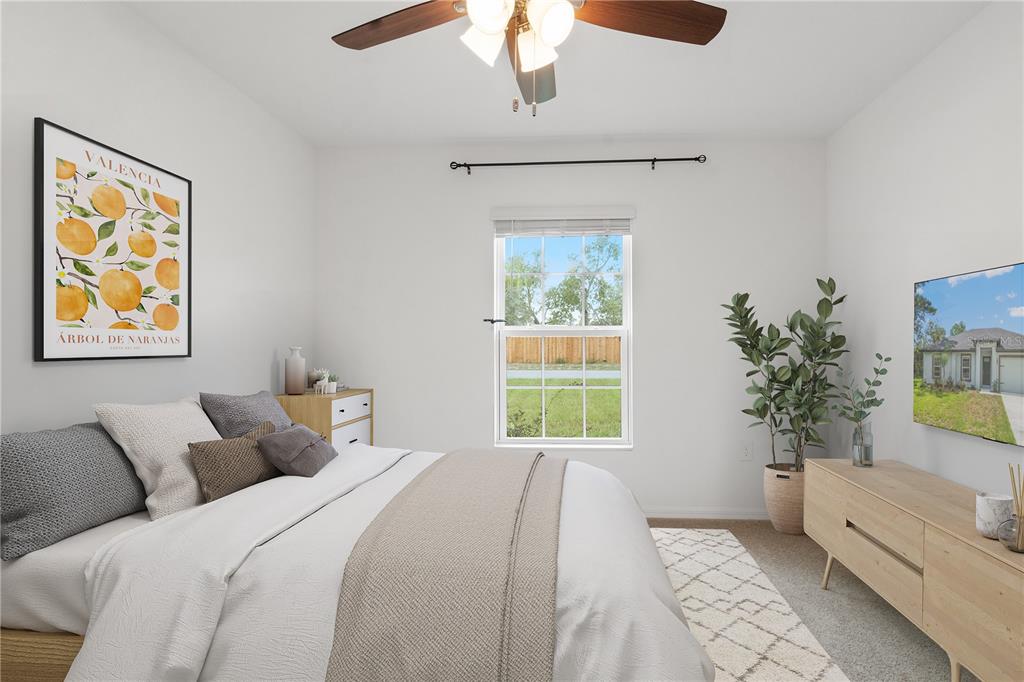 11380 Old Squaw Avenue Weeki Wachee, FL 34614 - Photo 11 of 23 a bedroom with a large bed and a window