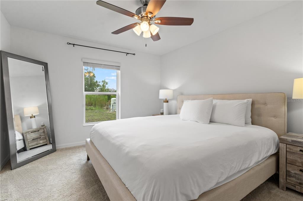 11380 Old Squaw Avenue Weeki Wachee, FL 34614 - Photo 12 of 23 a bedroom with a bed and a chandelier