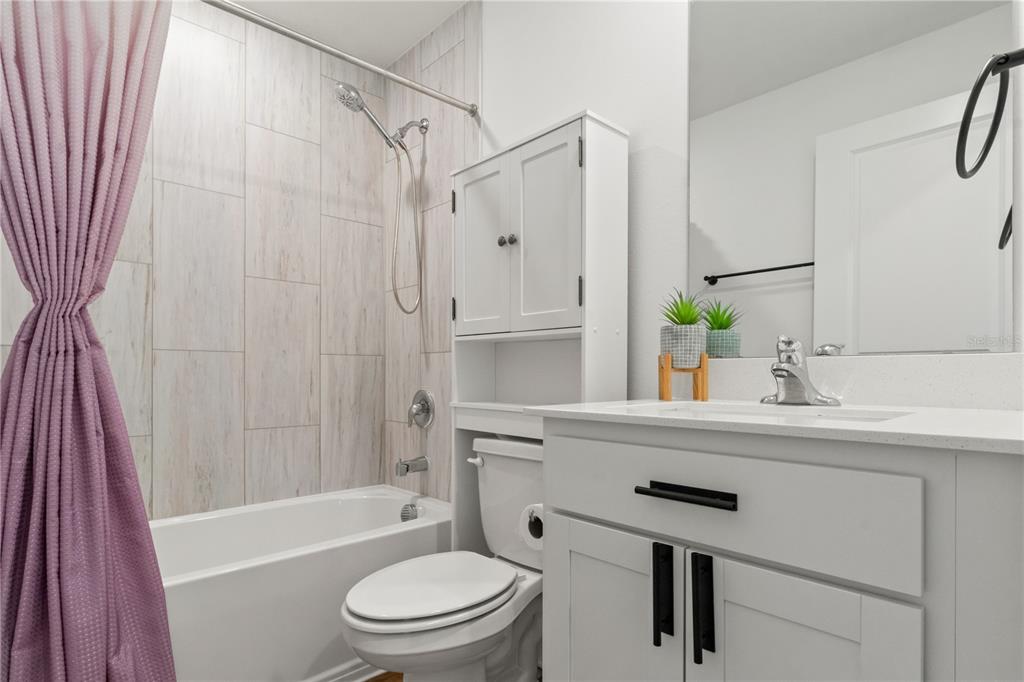 11380 Old Squaw Avenue Weeki Wachee, FL 34614 - Photo 13 of 23 a bathroom with a sink a toilet a tub and shower