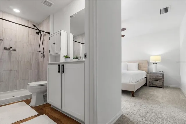 a spacious bathroom with a toilet and a shower