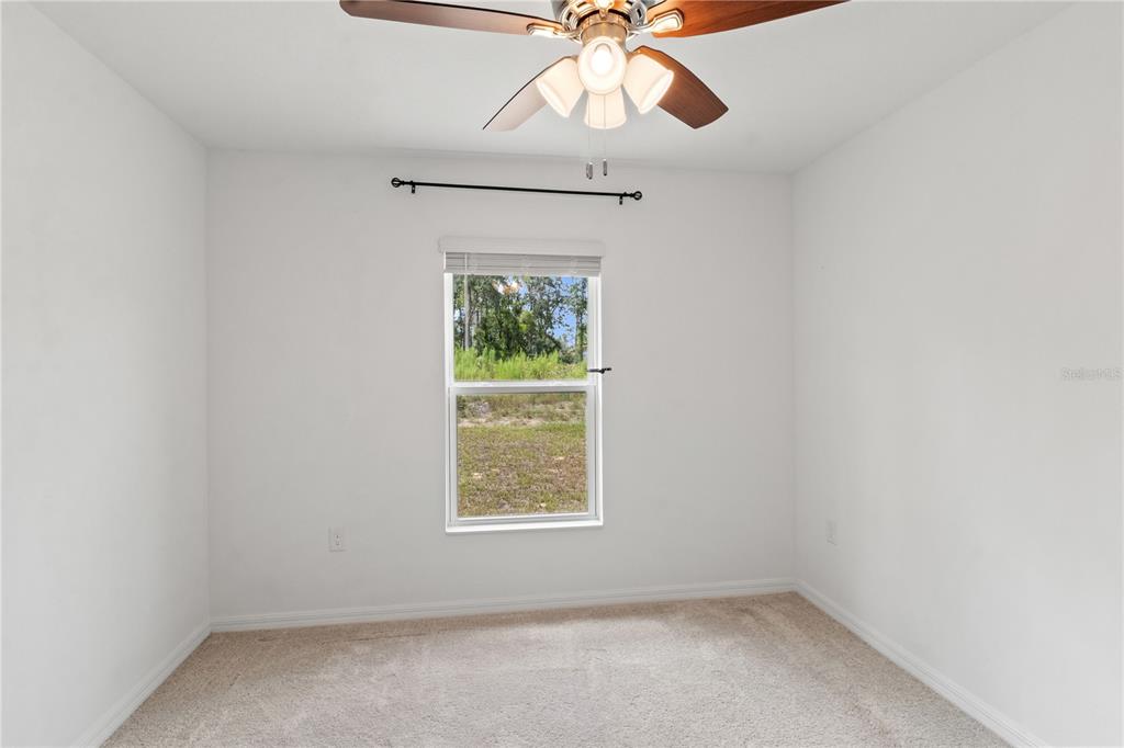 11380 Old Squaw Avenue Weeki Wachee, FL 34614 - Photo 17 of 23 an empty room with a window and a fan