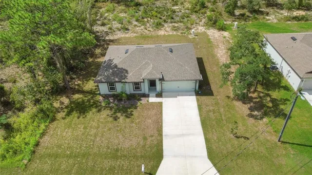 aerial view of a house with a yard