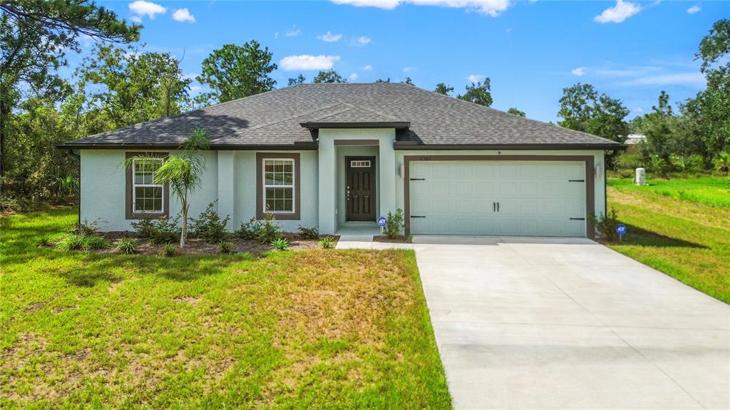 11380 Old Squaw Avenue Weeki Wachee, FL 34614 - Photo 21 of 23 front view of house with a yard
