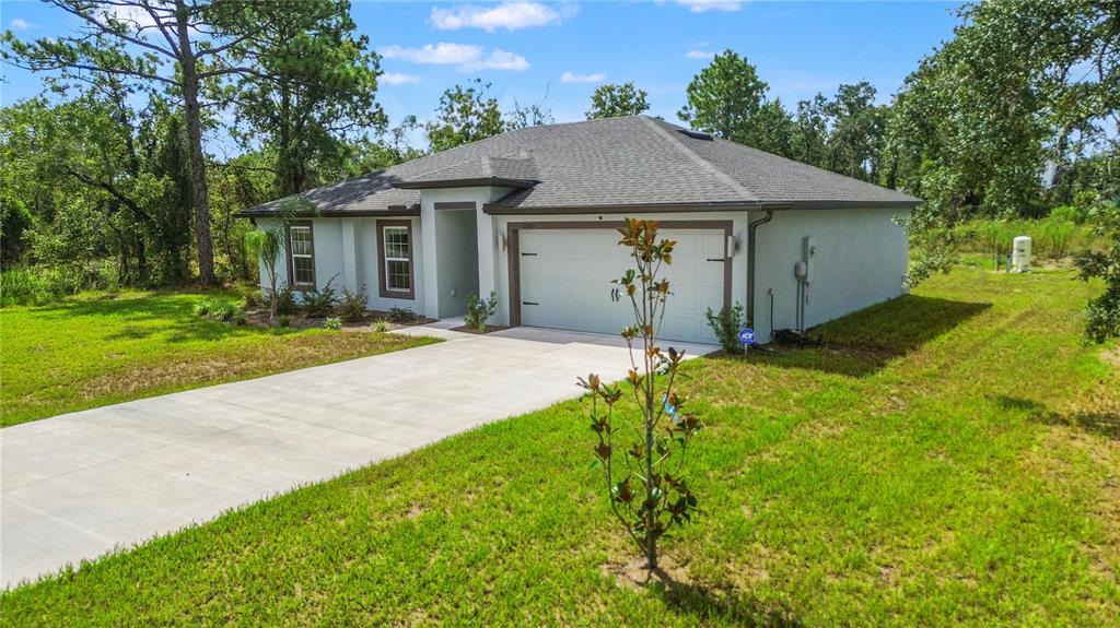 11380 Old Squaw Avenue Weeki Wachee, FL 34614 - Photo 3 of 23 a front view of house with yard and green space