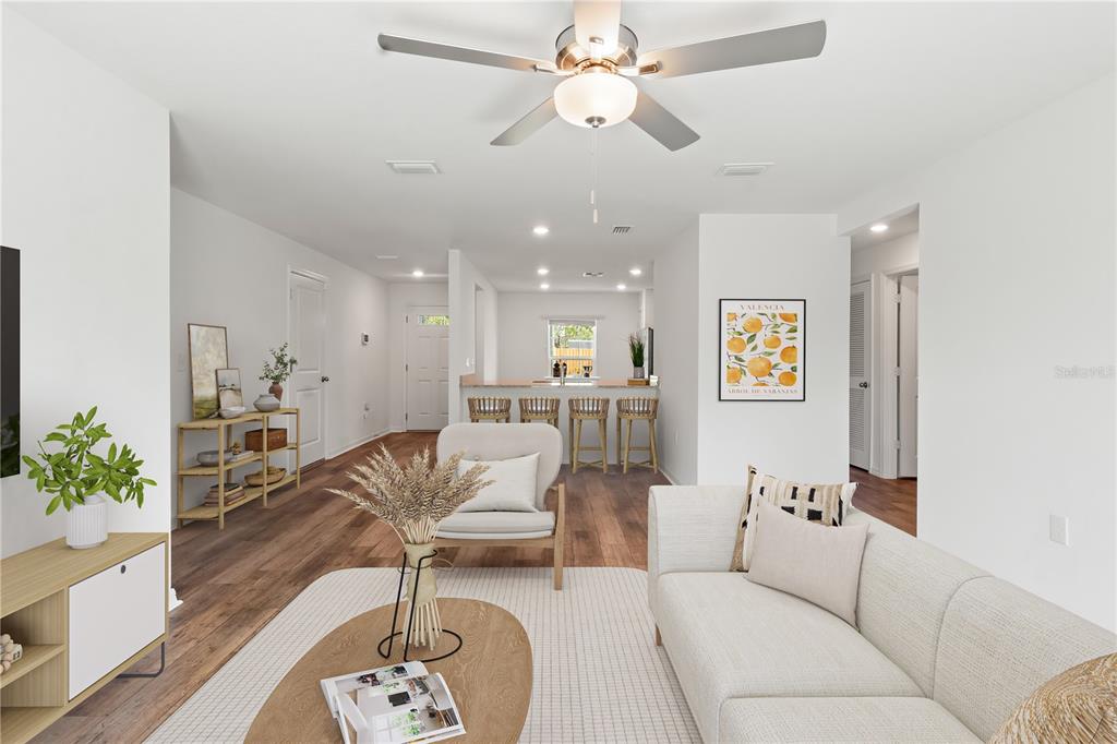 11380 Old Squaw Avenue Weeki Wachee, FL 34614 - Photo 5 of 23 a living room with furniture and a chandelier