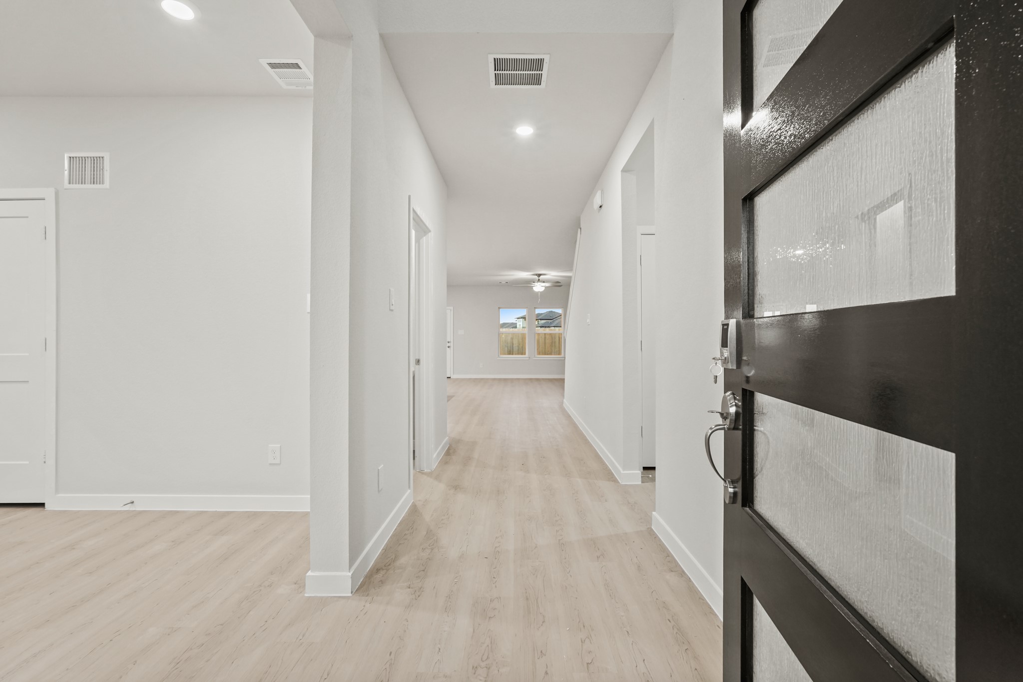 141 Byu Bnd Boulevard Angleton, TX 77515 - Photo 2 of 26 a view of a hallway with wooden floor and staircase