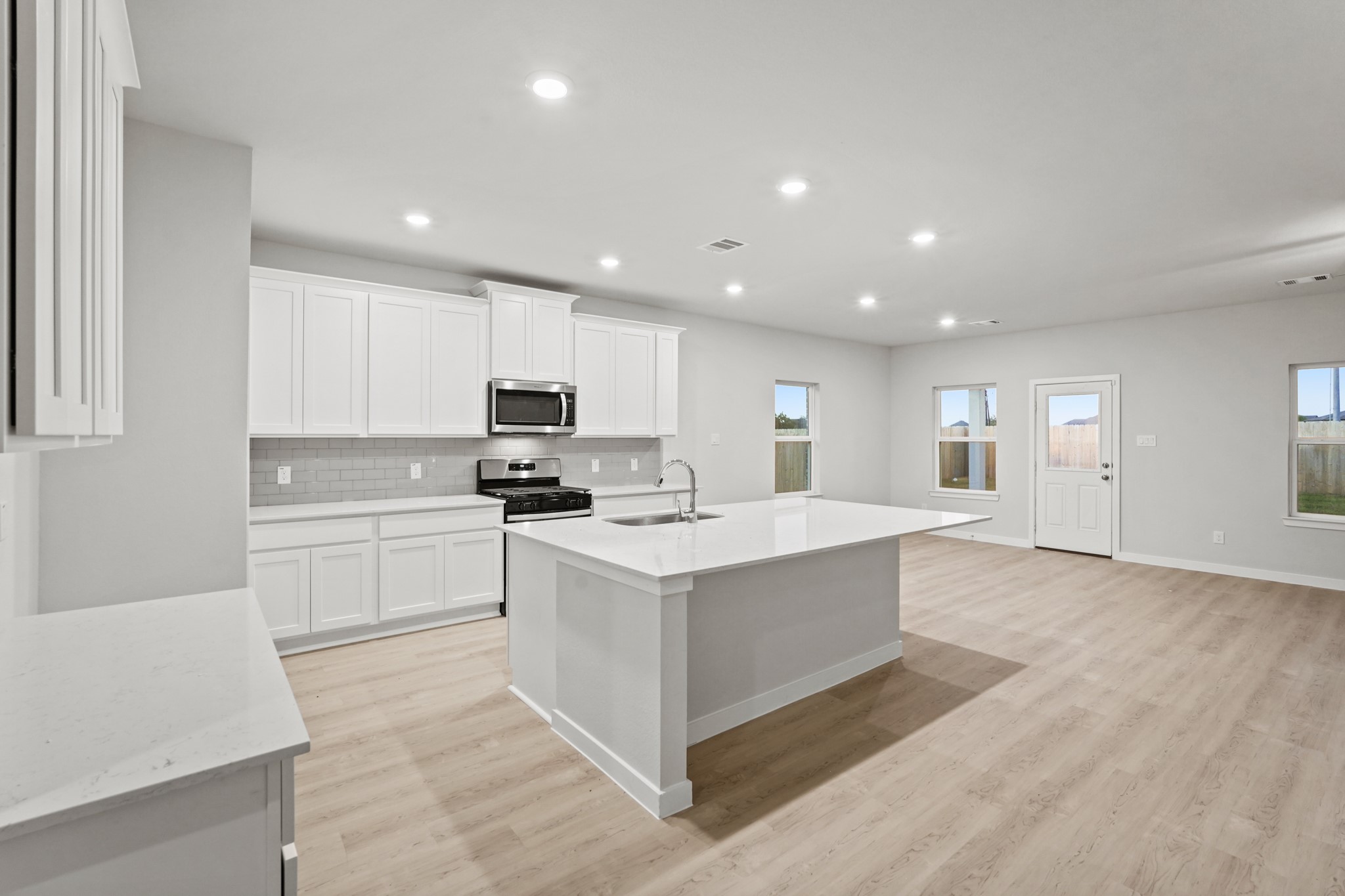 141 Byu Bnd Boulevard Angleton, TX 77515 - Photo 6 of 26 a kitchen with a sink stove and cabinets