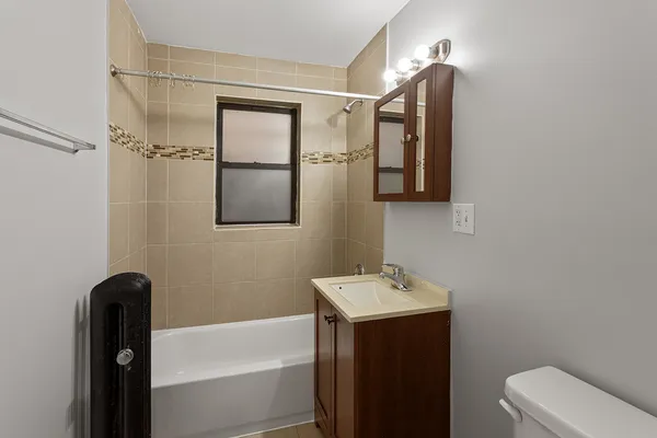 a bathroom with a sink and mirror with toilet