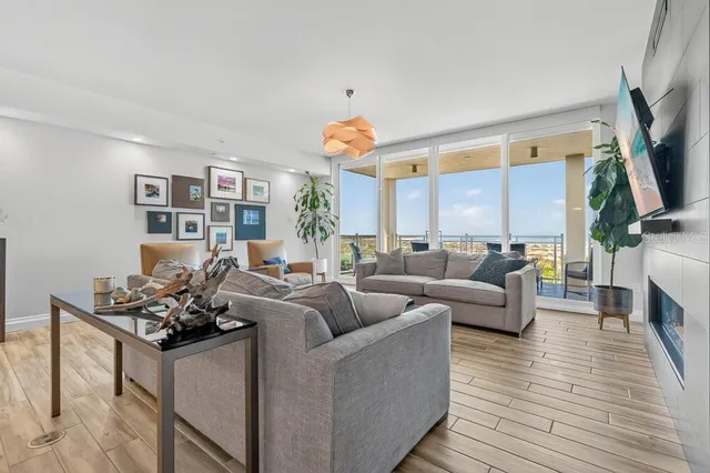 a living room with furniture flat screen tv and fireplace