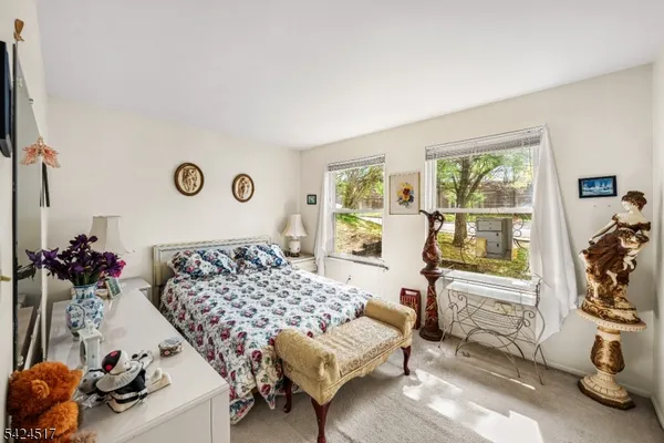 a bedroom with furniture and a large window