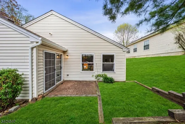 a view of a house with a backyard