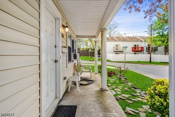 a view of a porch with chairs and backyard