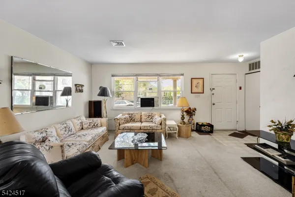 a living room with furniture large window and a table