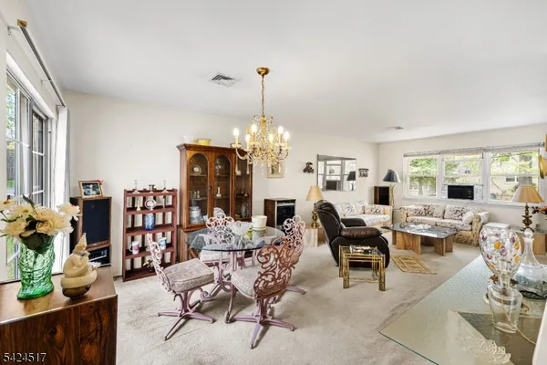 a living room with fireplace furniture and a chandelier
