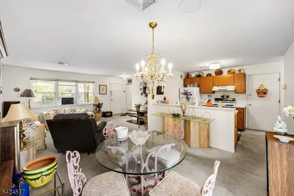 a living room with dining table and chairs