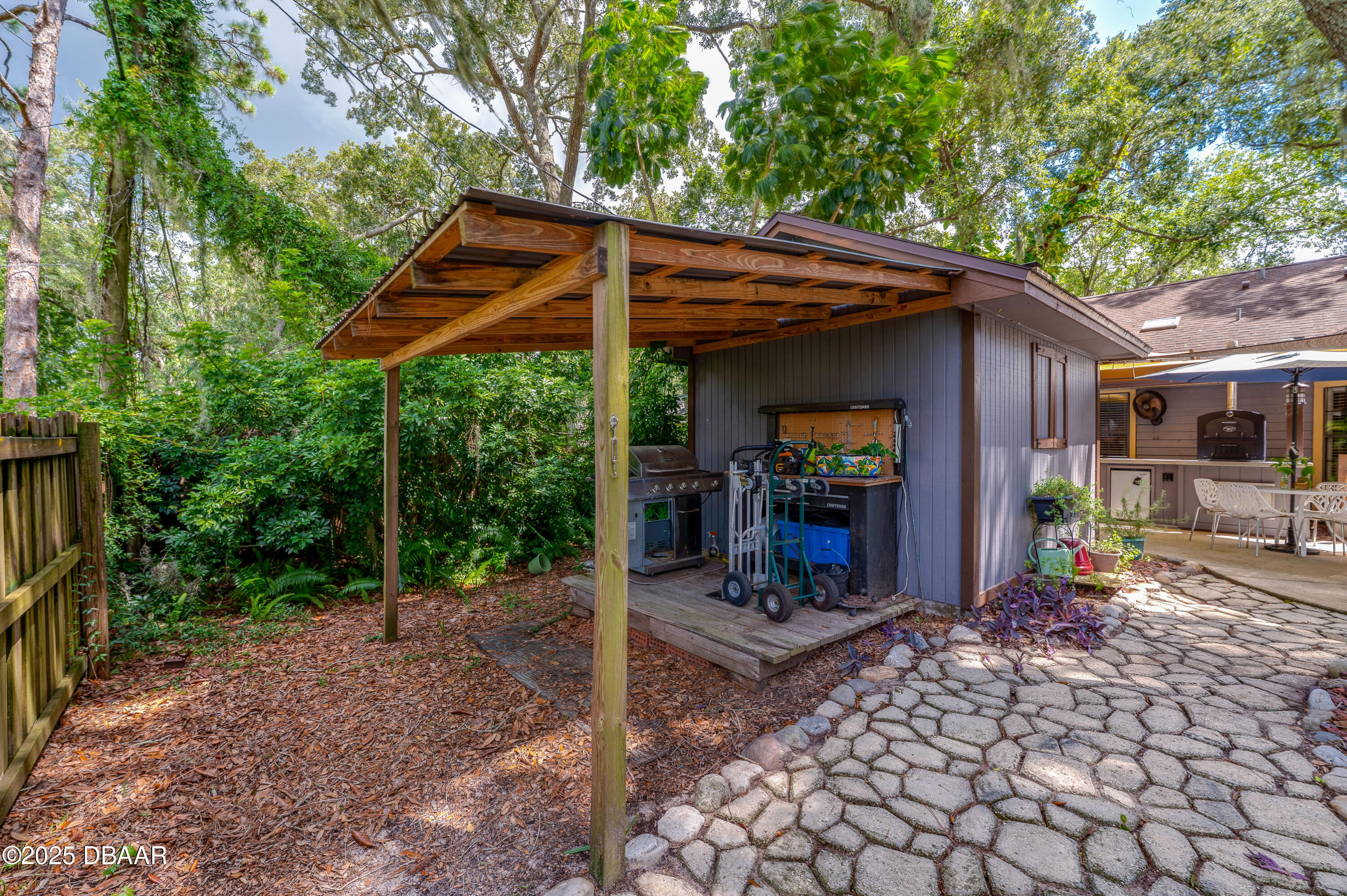 2824 Umbrella Tree Drive Edgewater, FL 32141 - Photo 31 of 36 a view of a chair and table in backyard of the house
