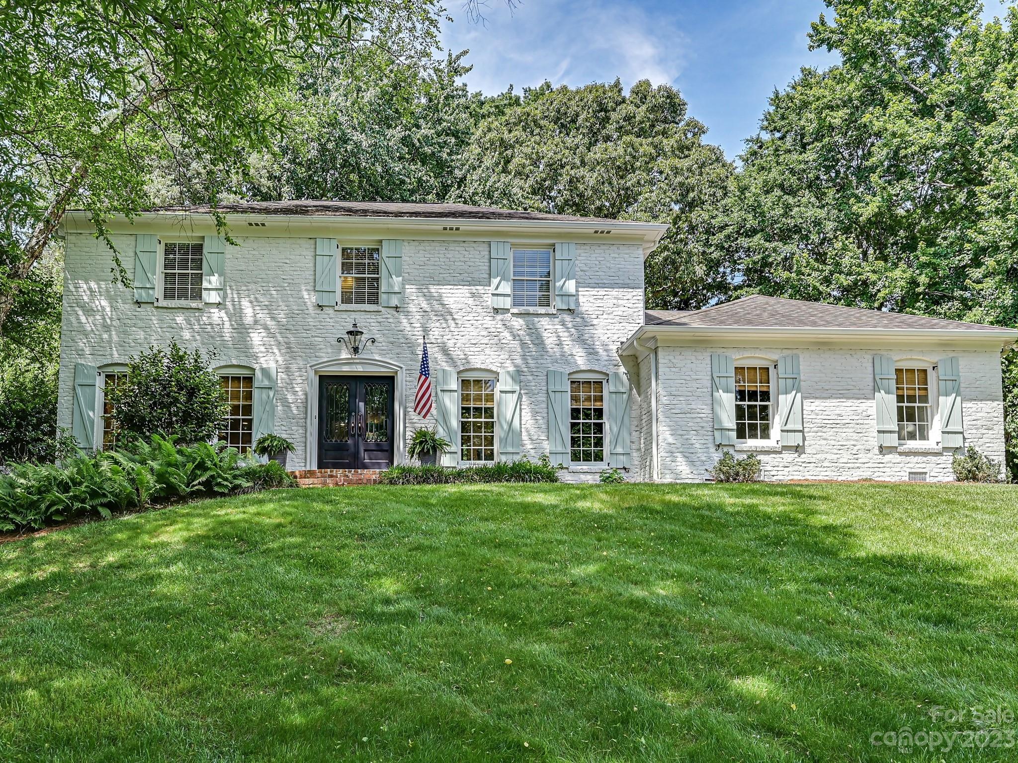 a front view of house with yard and green space