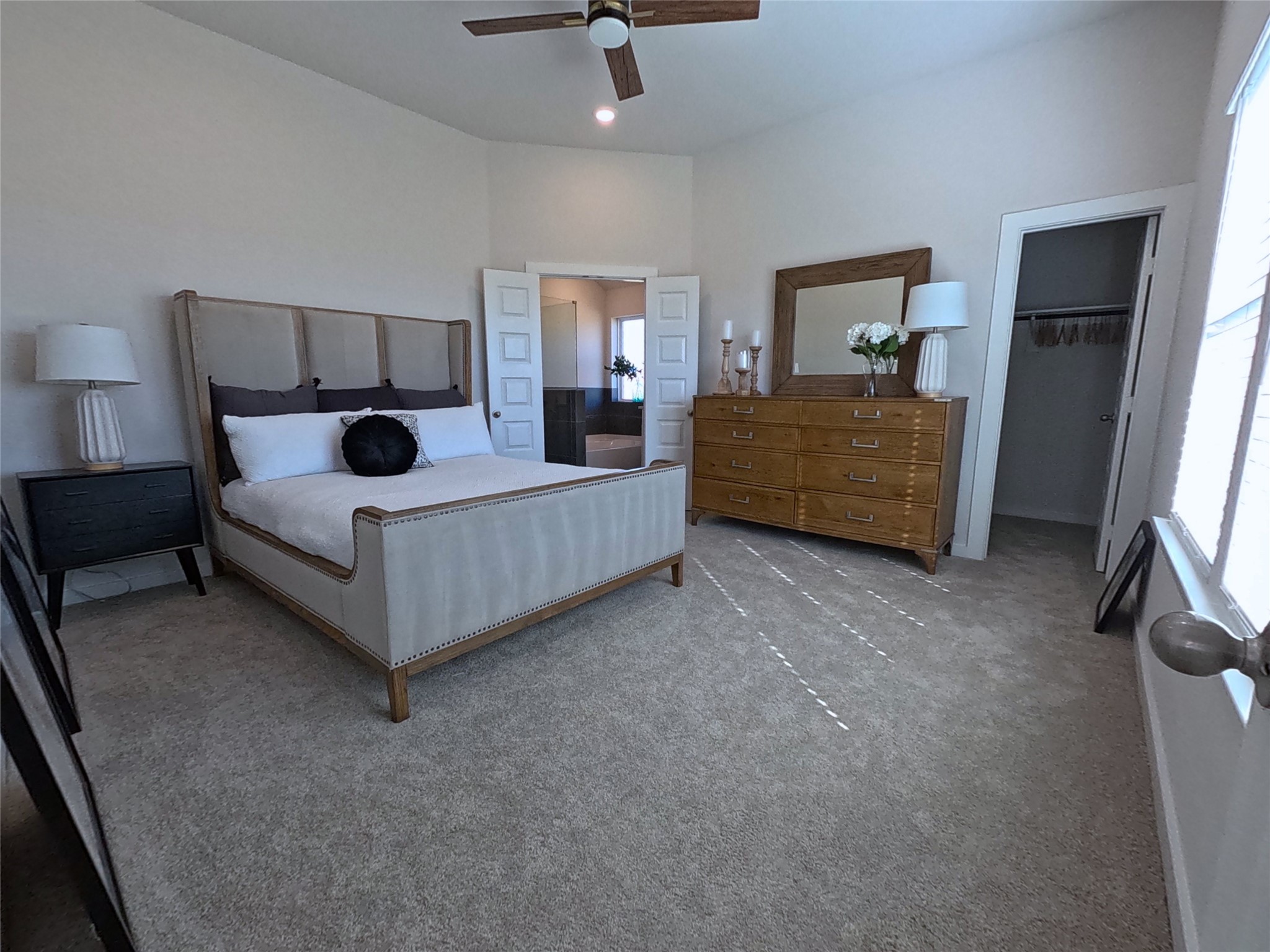 8323 Amber Summit Lane Angleton, TX 77515 - Photo 18 of 24 a bedroom with a bed a mirror and a window